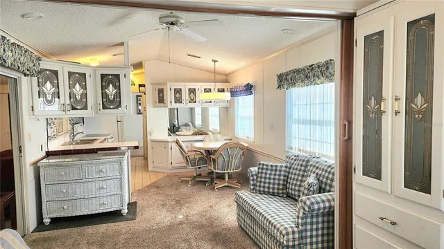 a kitchen with granite countertop white cabinets and white appliances
