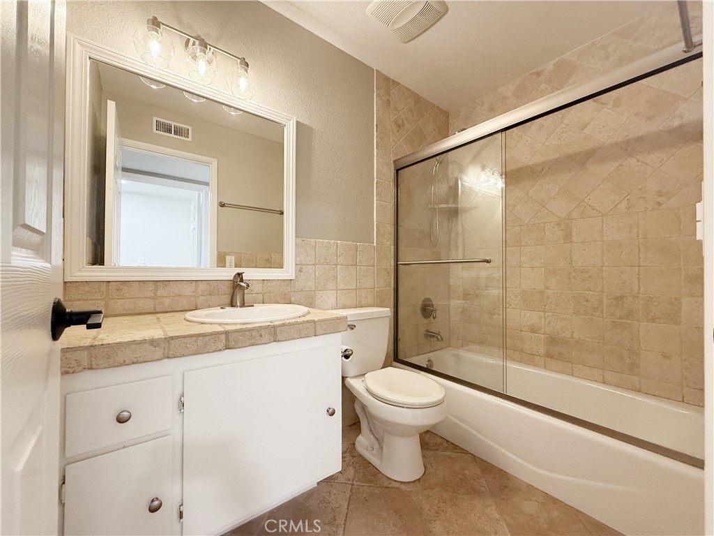 173 Oval Road, Unit 2 Irvine, CA 92604 - Photo 16 of 23 a bathroom with a sink toilet and shower