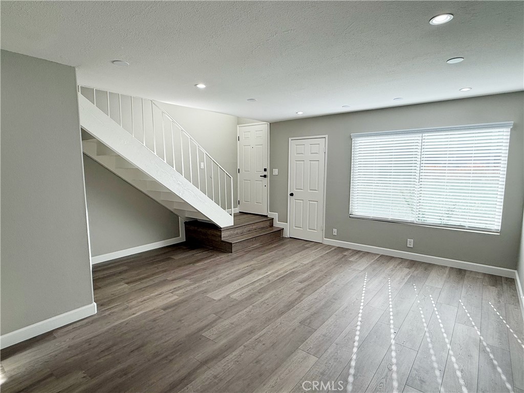 173 Oval Road, Unit 2 Irvine, CA 92604 - Photo 2 of 23 wooden floor in an empty room with a window