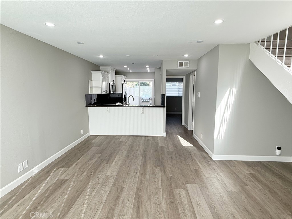 173 Oval Road, Unit 2 Irvine, CA 92604 - Photo 5 of 23 a view of a kitchen with wooden floor and a sink