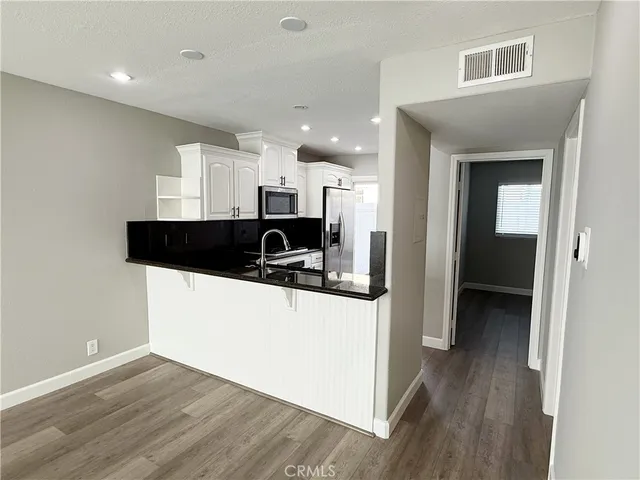 a view of a kitchen cabinets and a wooden floor