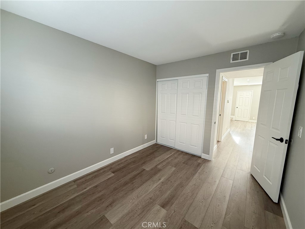 173 Oval Road, Unit 2 Irvine, CA 92604 - Photo 9 of 23 wooden floor in an empty room