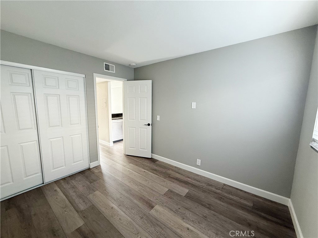 173 Oval Road, Unit 2 Irvine, CA 92604 - Photo 10 of 23 a view of an empty room with wooden floor