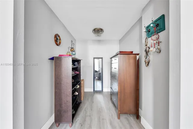 a view of a hallway with wooden floor and entryway