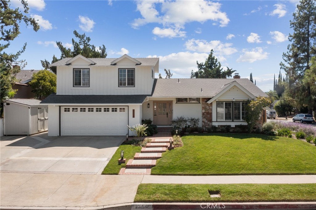 23546 Community Street West Hills, CA 91304 - Photo 1 of 1 a front view of house with yard and outdoor seating