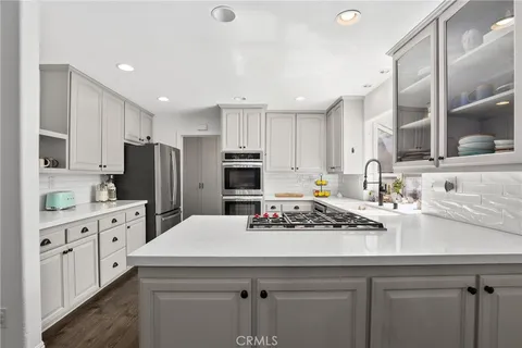 a kitchen with refrigerator a sink and cabinets