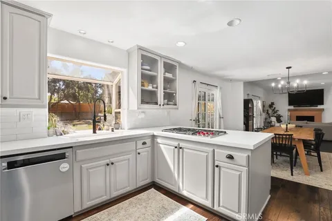 a kitchen with a sink stove and cabinets