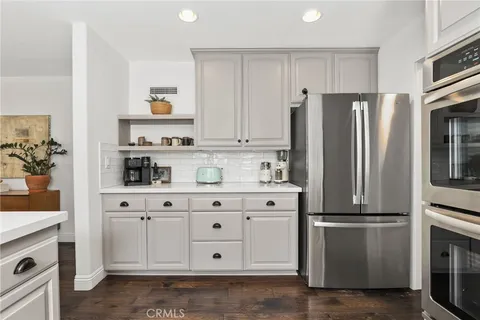 a kitchen with stainless steel appliances a refrigerator sink and cabinets