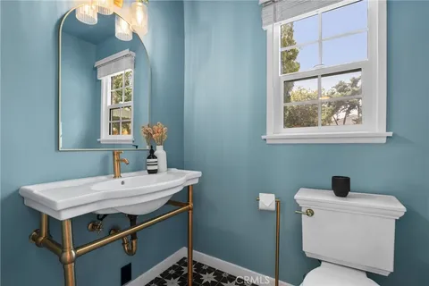 a bathroom with a toilet a sink and a mirror