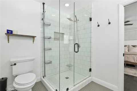 a bathroom with a shower toilet and sink