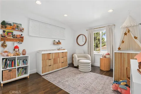 a living room with furniture and a baby crib