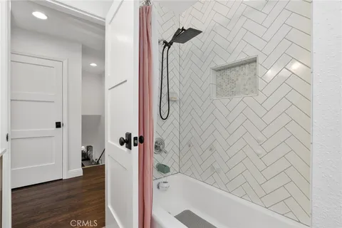 a bathroom with a bathtub and a shower