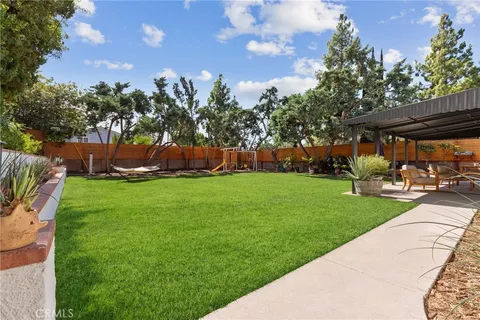 a view of a backyard with sitting area