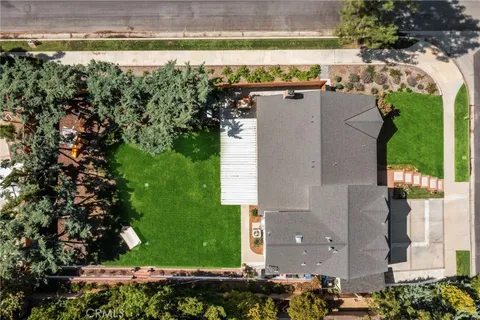 an aerial view of residential houses with outdoor space and swimming pool