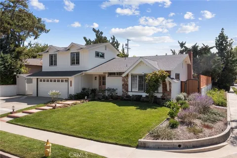 a view of a house with swimming pool and a yard
