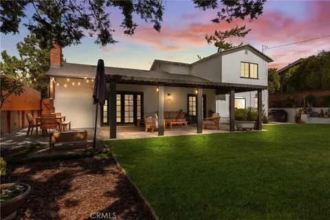 a front view of a house with swimming pool having outdoor seating