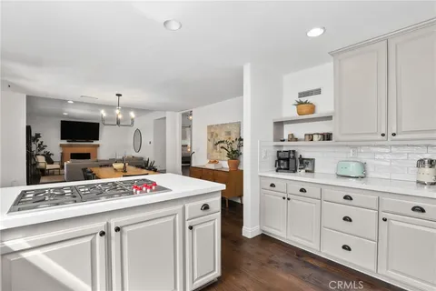 a kitchen that has a lot of cabinets in it and wooden floors