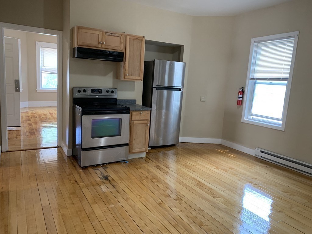 5 Rose Street Worcester, MA 01607 - Photo 11 of 30 a kitchen with stainless steel appliances a refrigerator and a stove top oven