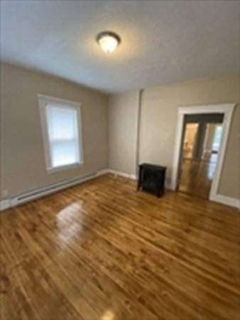 5 Rose Street Worcester, MA 01607 - Photo 19 of 30 a view of empty room with wooden floor and window