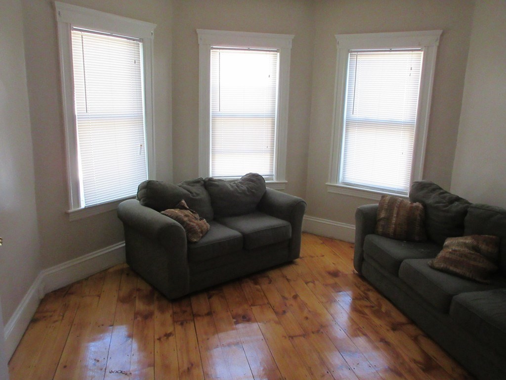 5 Rose Street Worcester, MA 01607 - Photo 2 of 30 a living room with furniture and windows
