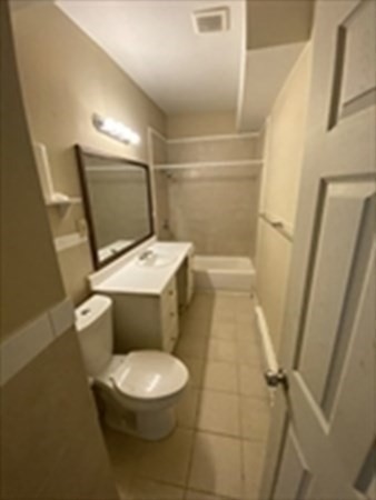 5 Rose Street Worcester, MA 01607 - Photo 23 of 30 a white toilet sitting next to a bathroom sink