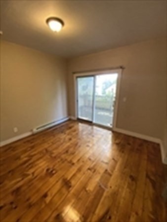 5 Rose Street Worcester, MA 01607 - Photo 24 of 30 an empty room with wooden floor and windows
