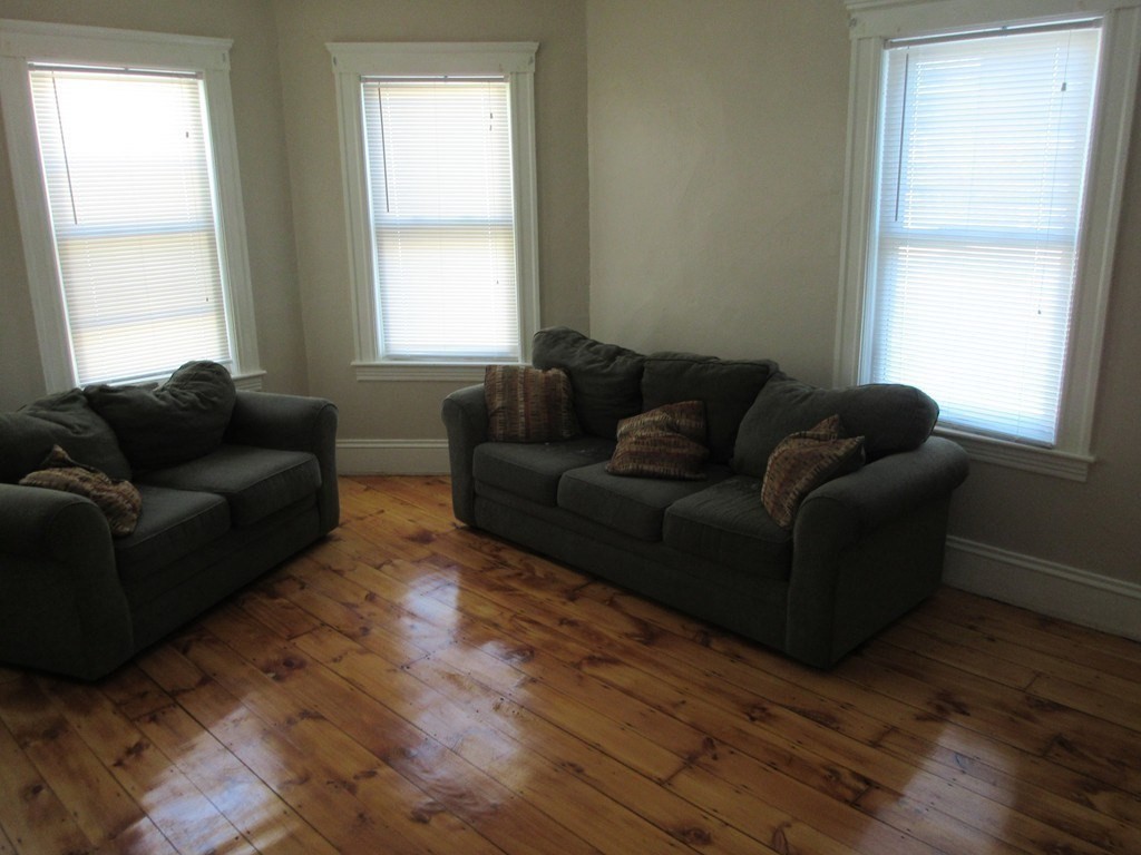 5 Rose Street Worcester, MA 01607 - Photo 3 of 30 a living room with furniture and windows