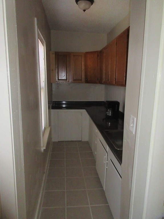 5 Rose Street Worcester, MA 01607 - Photo 5 of 30 a kitchen with a sink and cabinets