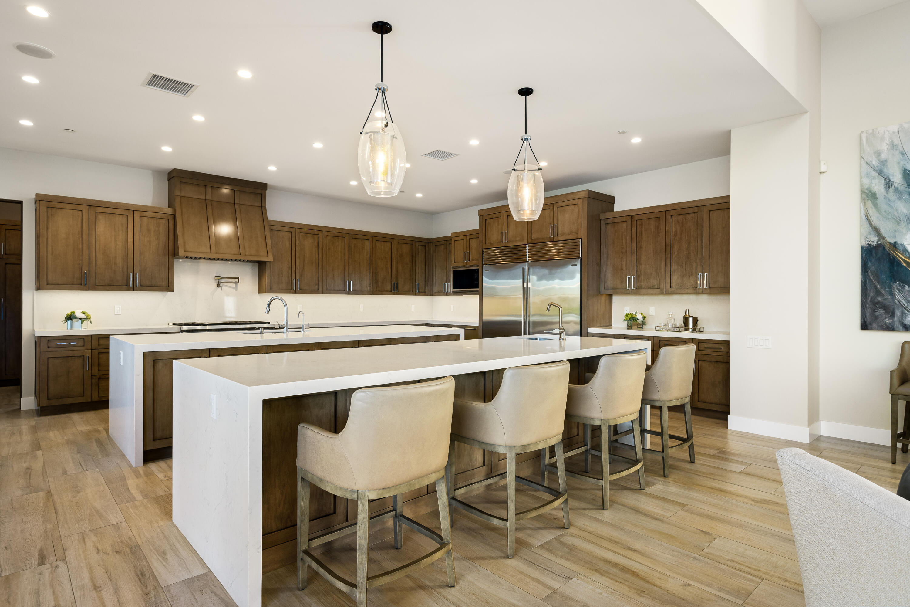53488 Via Strada La Quinta, CA 92253 - Photo 11 of 56 a kitchen with a dining table chairs wooden floor cabinets and appliances
