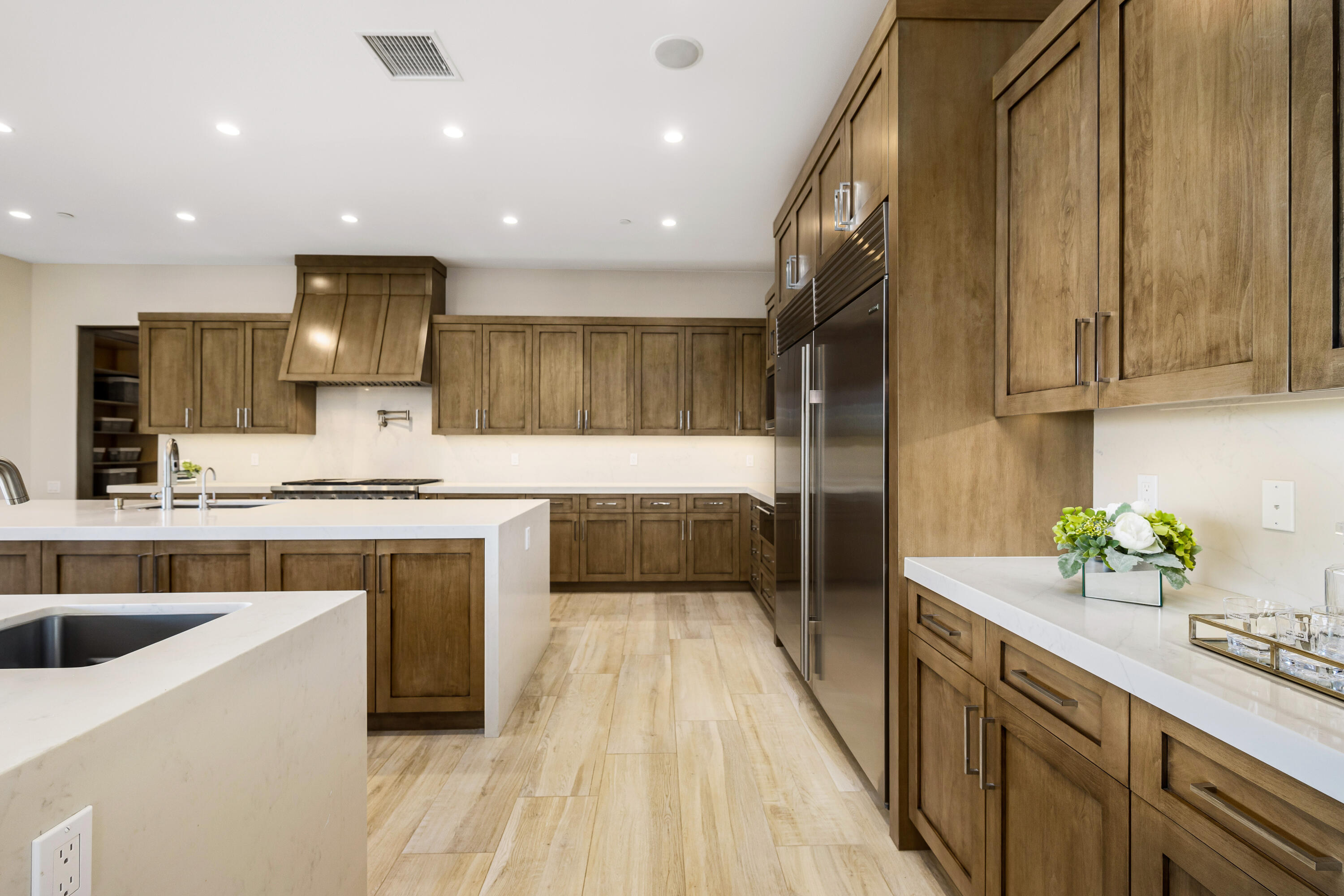 53488 Via Strada La Quinta, CA 92253 - Photo 14 of 56 a kitchen with a sink stainless steel appliances a counter top space cabinets and a sink