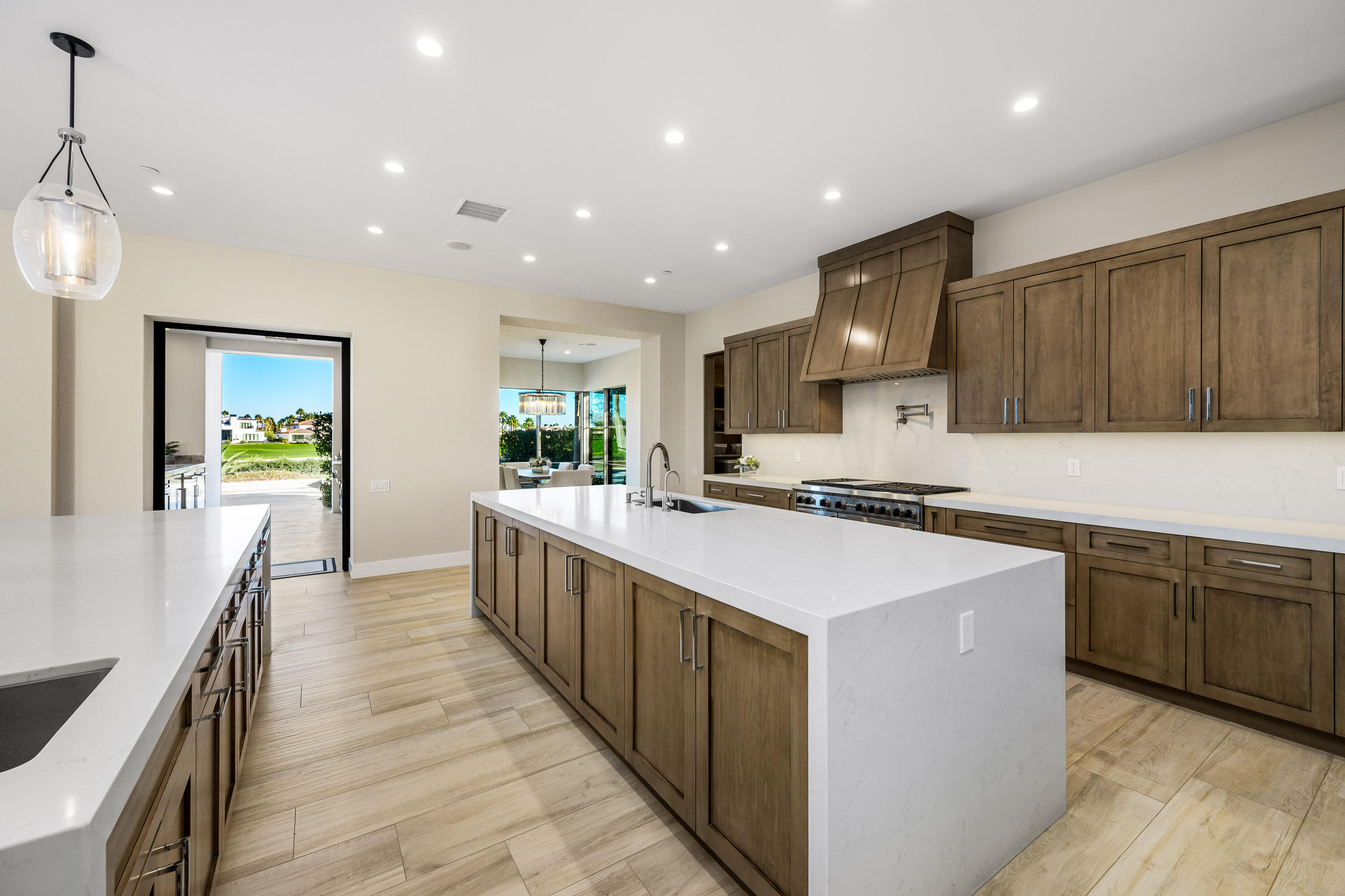 53488 Via Strada La Quinta, CA 92253 - Photo 15 of 56 a large kitchen with stainless steel appliances lots of counter space and wooden floor