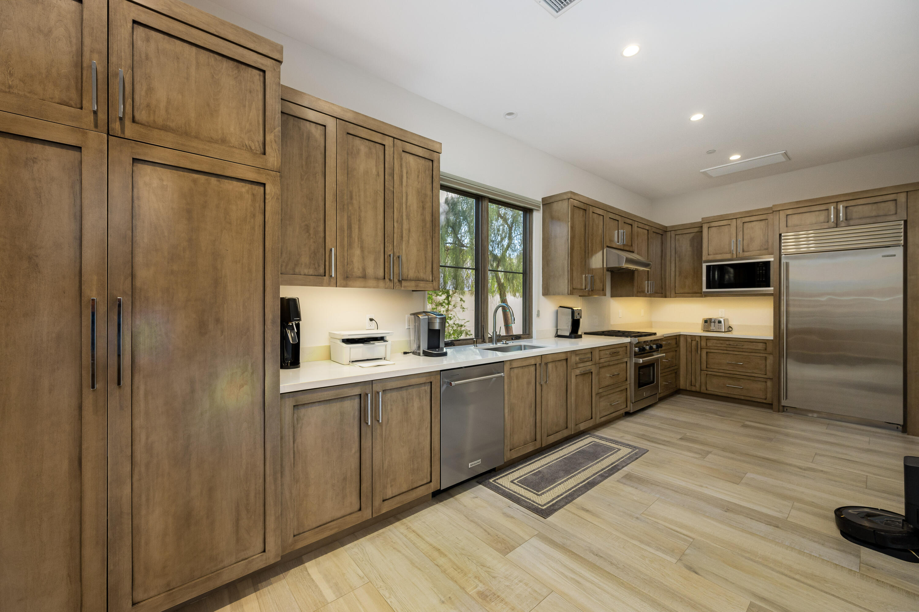 53488 Via Strada La Quinta, CA 92253 - Photo 16 of 56 a large kitchen with a refrigerator a sink and dishwasher a oven with wooden floor