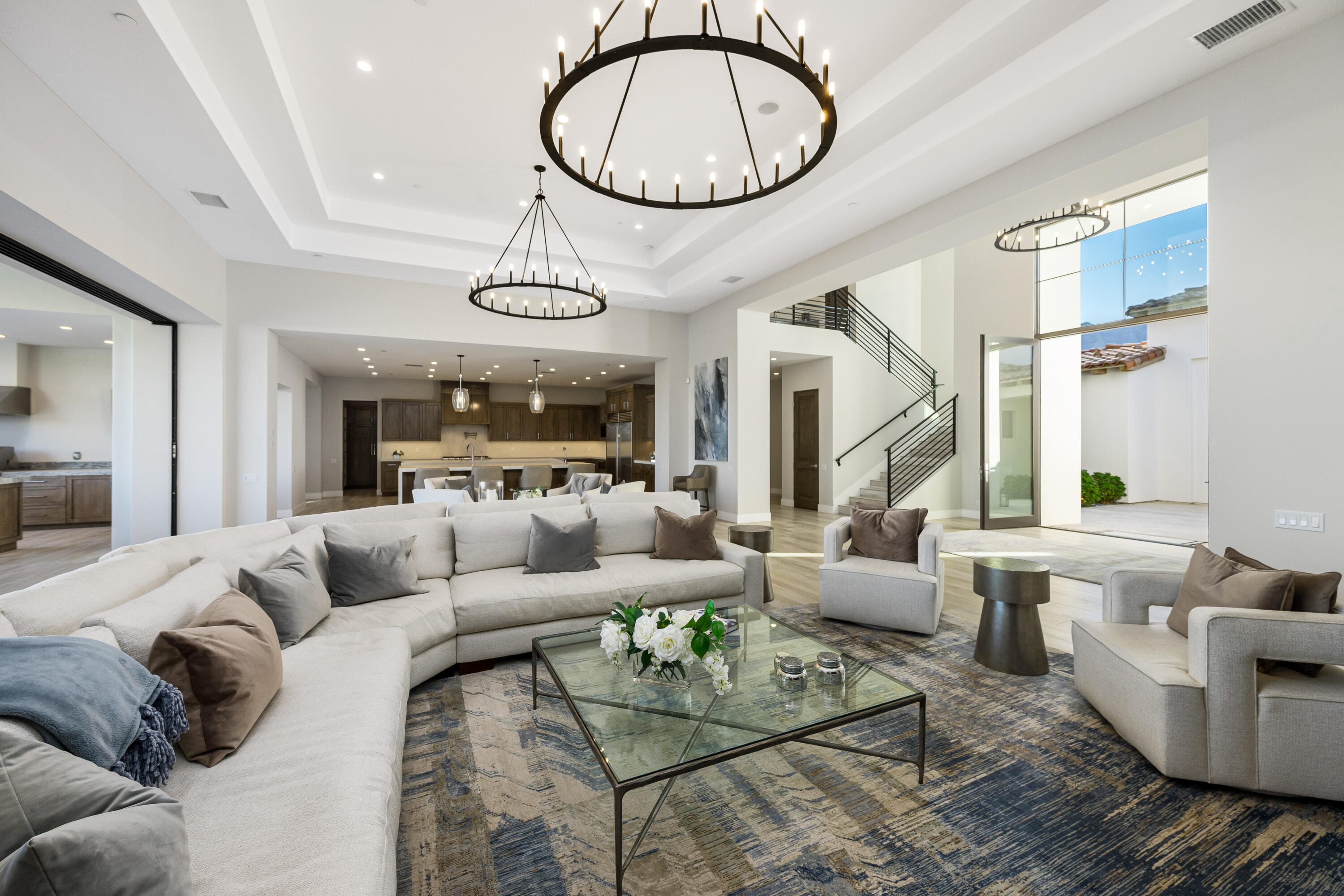 53488 Via Strada La Quinta, CA 92253 - Photo 10 of 56 a living room with furniture a fireplace and a chandelier