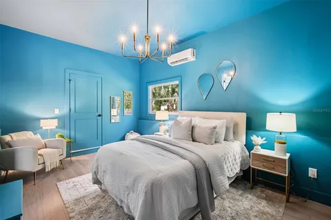 a bedroom with bed and a chandelier