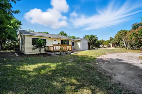 a view of house with yard and green space