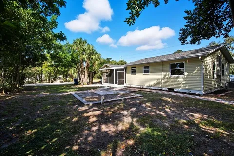 a backyard of a house with large trees
