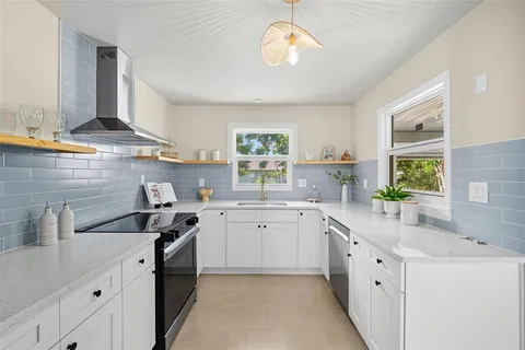 a kitchen that has a lot of cabinets in it