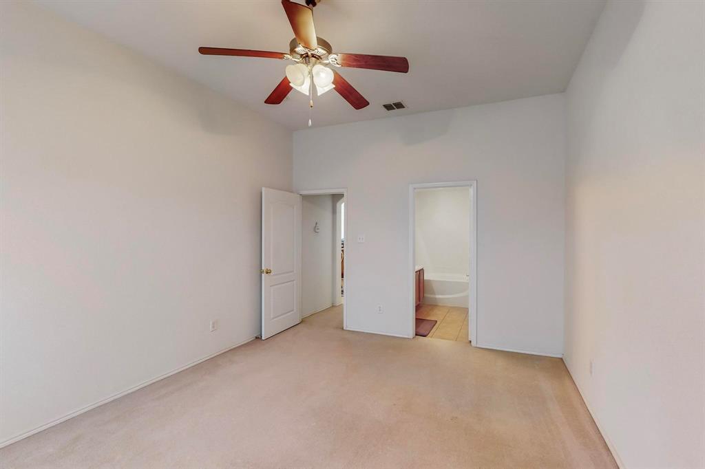 7544 Fresh Springs Road Fort Worth, TX 76120 - Photo 10 of 16 en empty room with ceiling fan and window