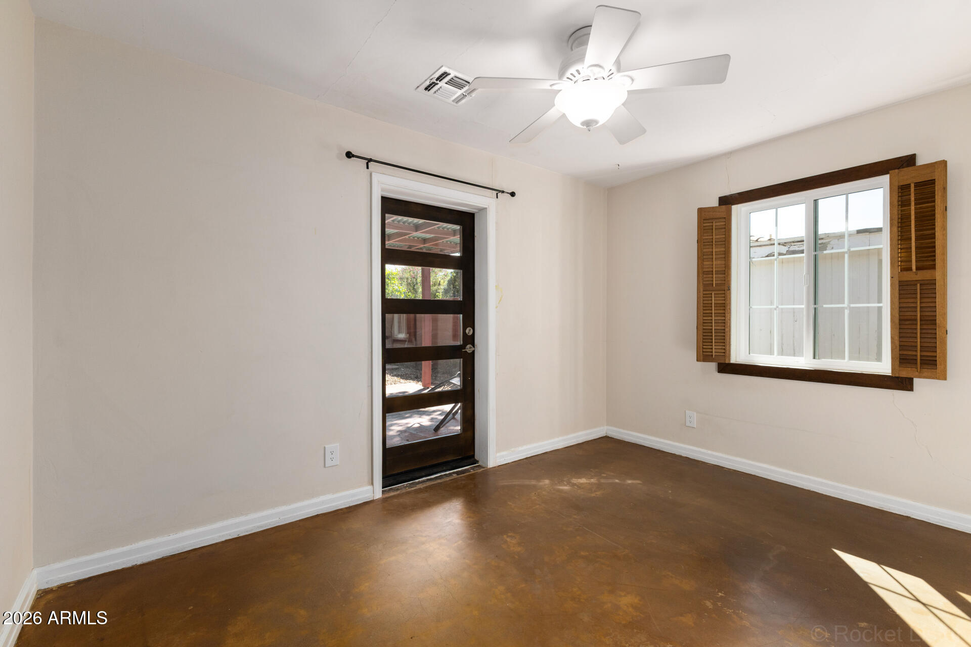 1307 West Thomas Road Phoenix, AZ 85007 - Photo 20 of 35 an empty room with windows and fan