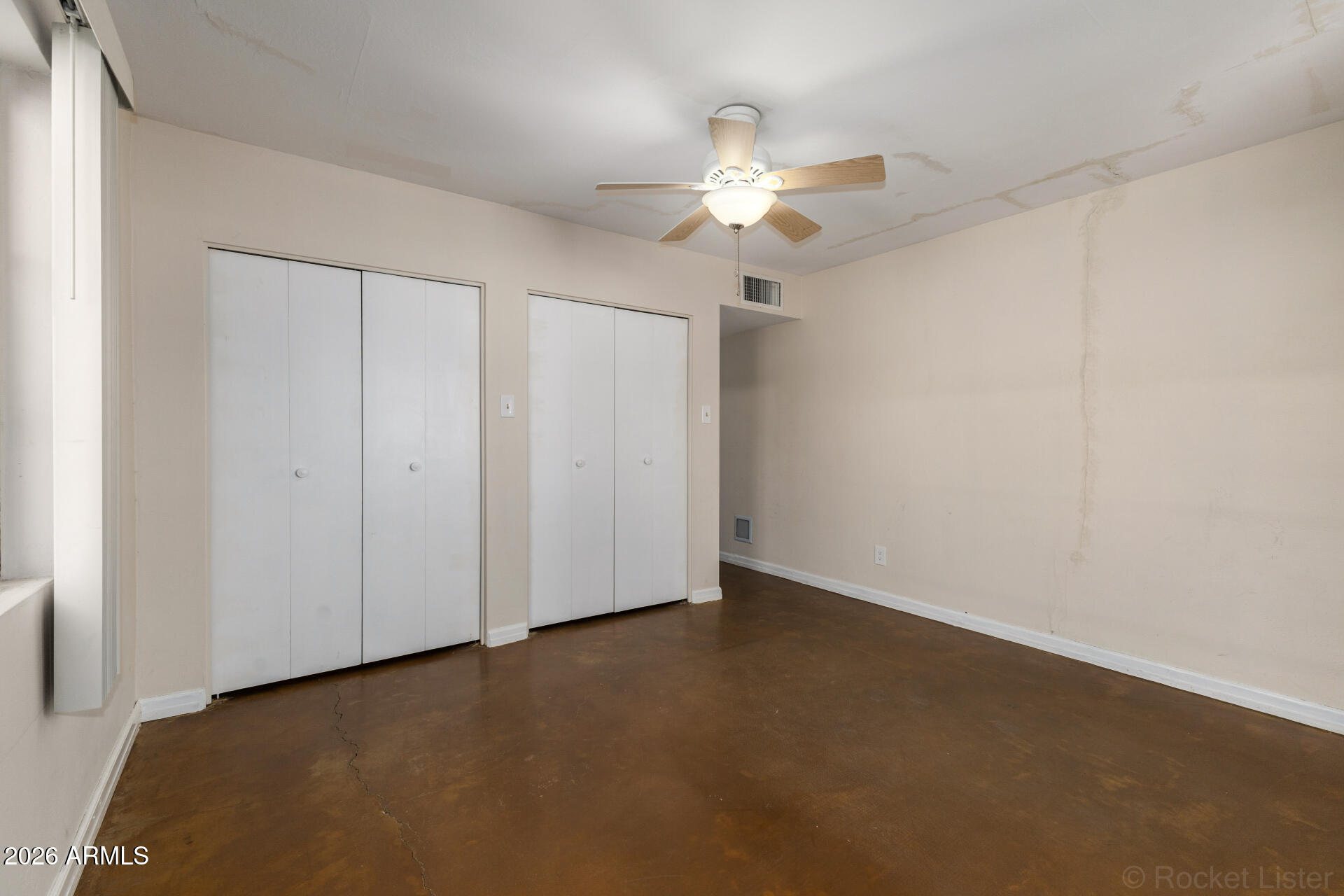 1307 West Thomas Road Phoenix, AZ 85007 - Photo 24 of 35 an empty room with a chandelier fan