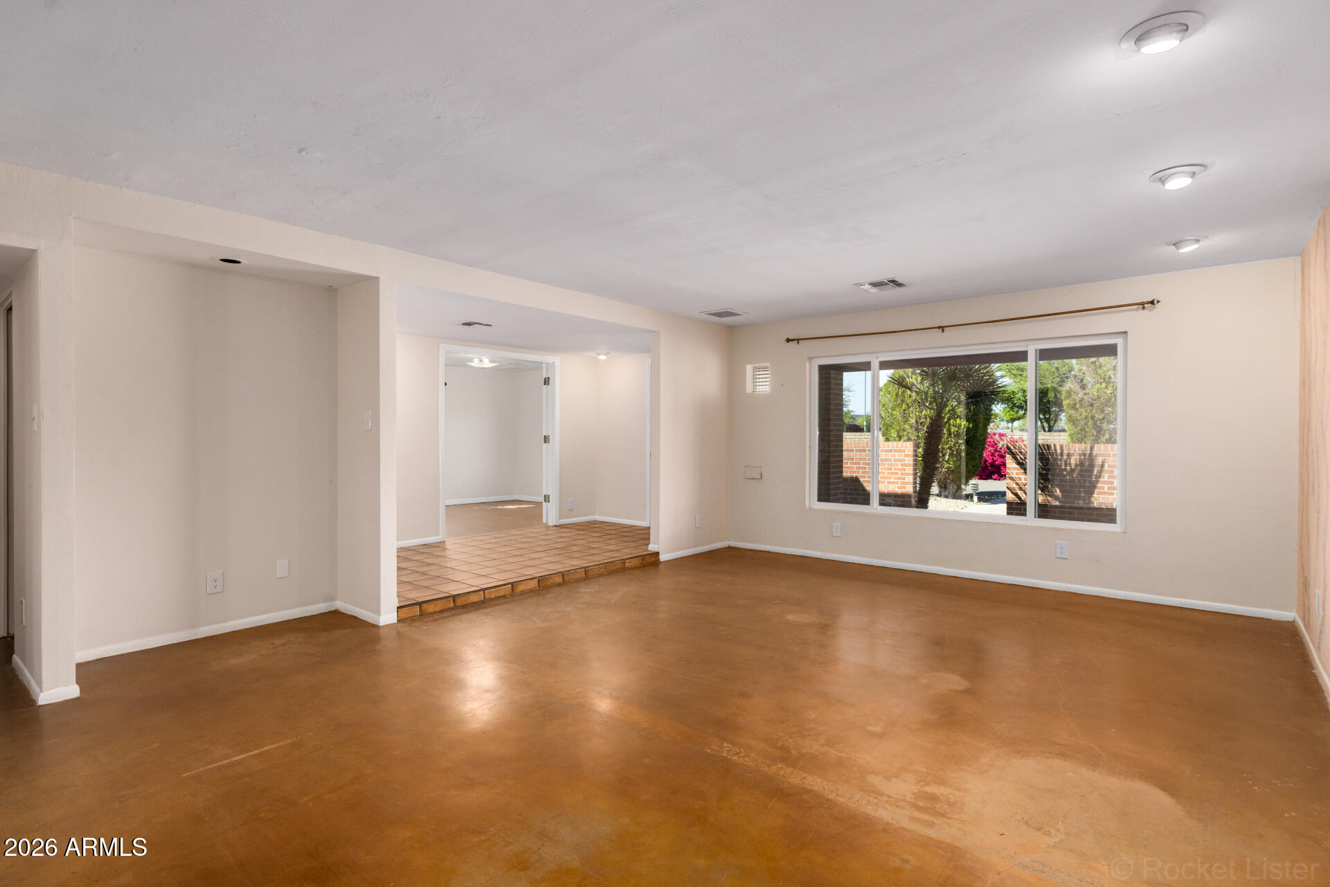 1307 West Thomas Road Phoenix, AZ 85007 - Photo 9 of 35 an empty room with floor to ceiling window and wooden floor