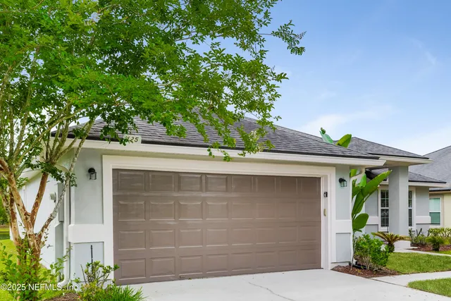 front view of a house with a tree