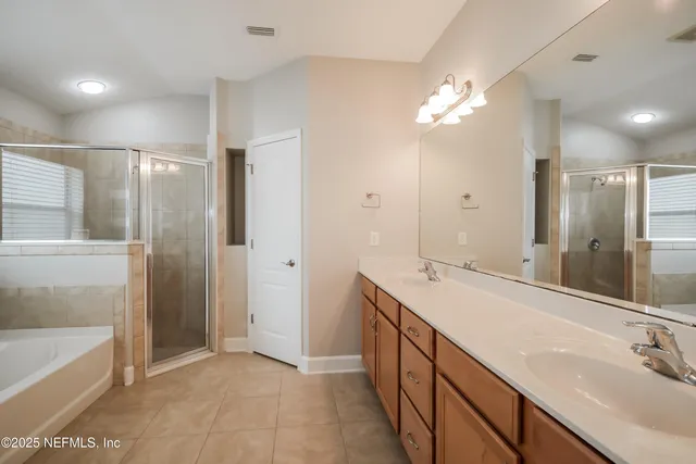 a bathroom with a sink double vanity and a shower