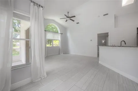 an empty room with a empty space and a ceiling fan