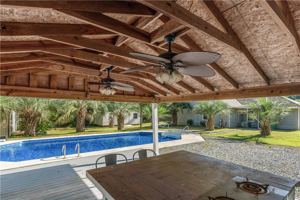 4 Ford Road Phenix City, AL 36869 - Photo 35 of 52 Covered patio with exposed wood beams, dual ceiling fans, and a built-in outdoor cooking station