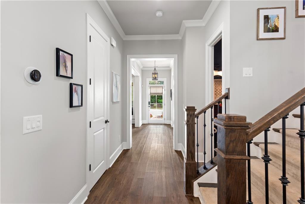 126 Academy Street Alpharetta, GA 30009 - Photo 14 of 74 a view of a hallway with wooden floor and staircase