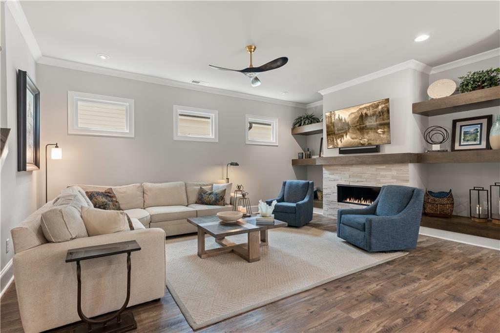 126 Academy Street Alpharetta, GA 30009 - Photo 30 of 74 a living room with furniture and a fireplace