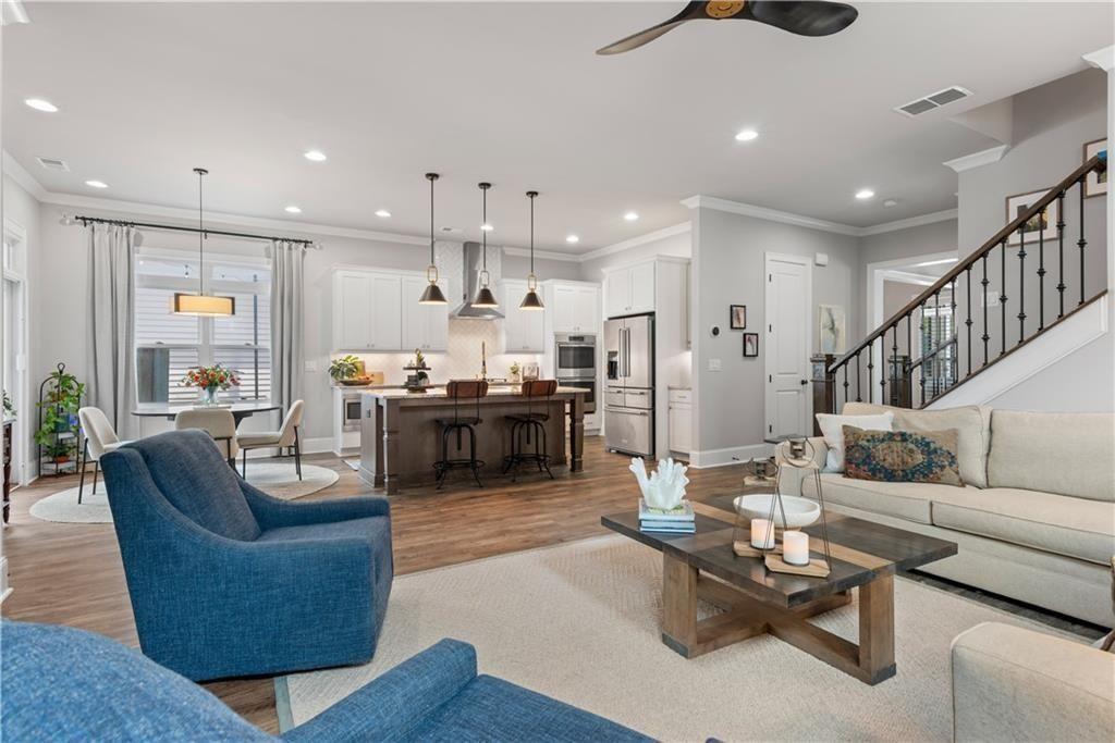 126 Academy Street Alpharetta, GA 30009 - Photo 31 of 74 a living room with furniture kitchen view and a chandelier