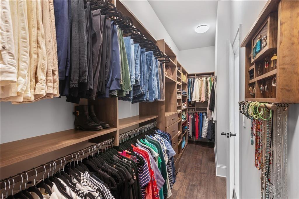 126 Academy Street Alpharetta, GA 30009 - Photo 41 of 74 a view of walk in closet with clothes and shoes