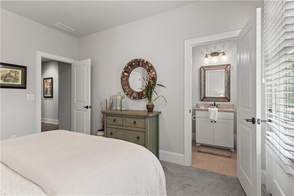 126 Academy Street Alpharetta, GA 30009 - Photo 44 of 74 a bedroom with a bed and a mirror
